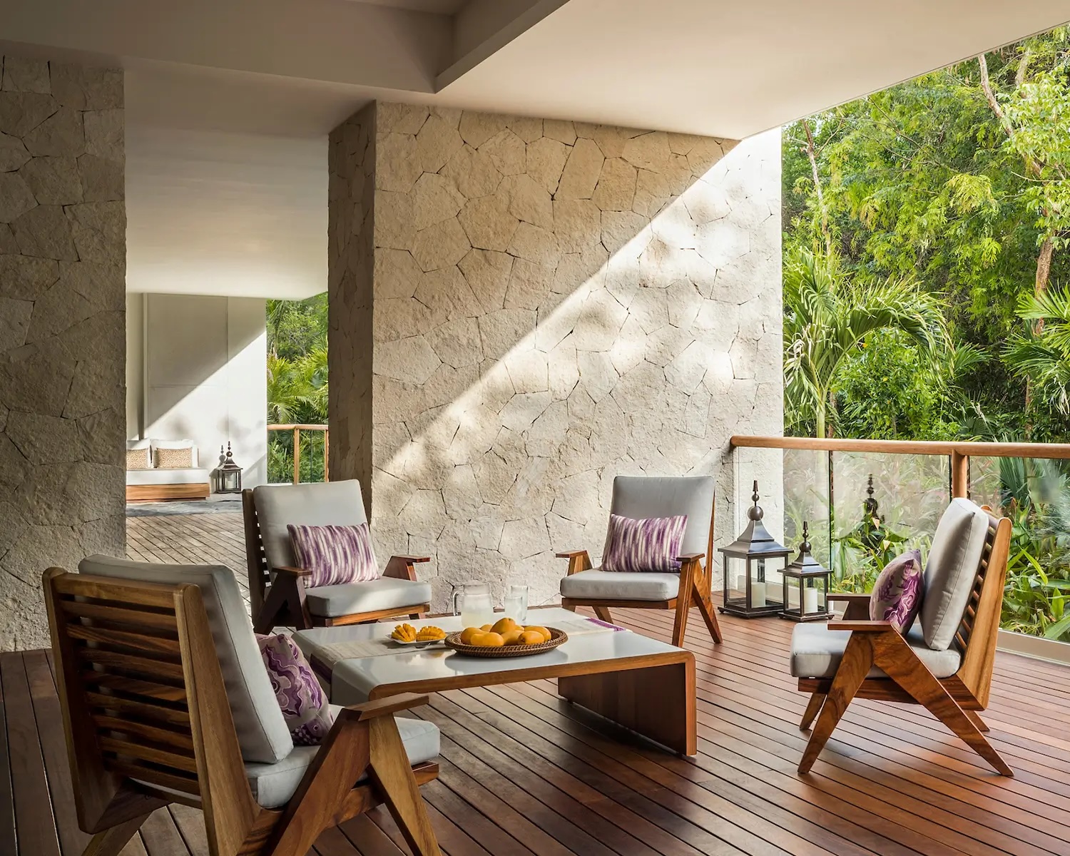 Private terrace at Grand Luxxe in Vidanta Riviera Maya, featuring wood furniture and jungle views