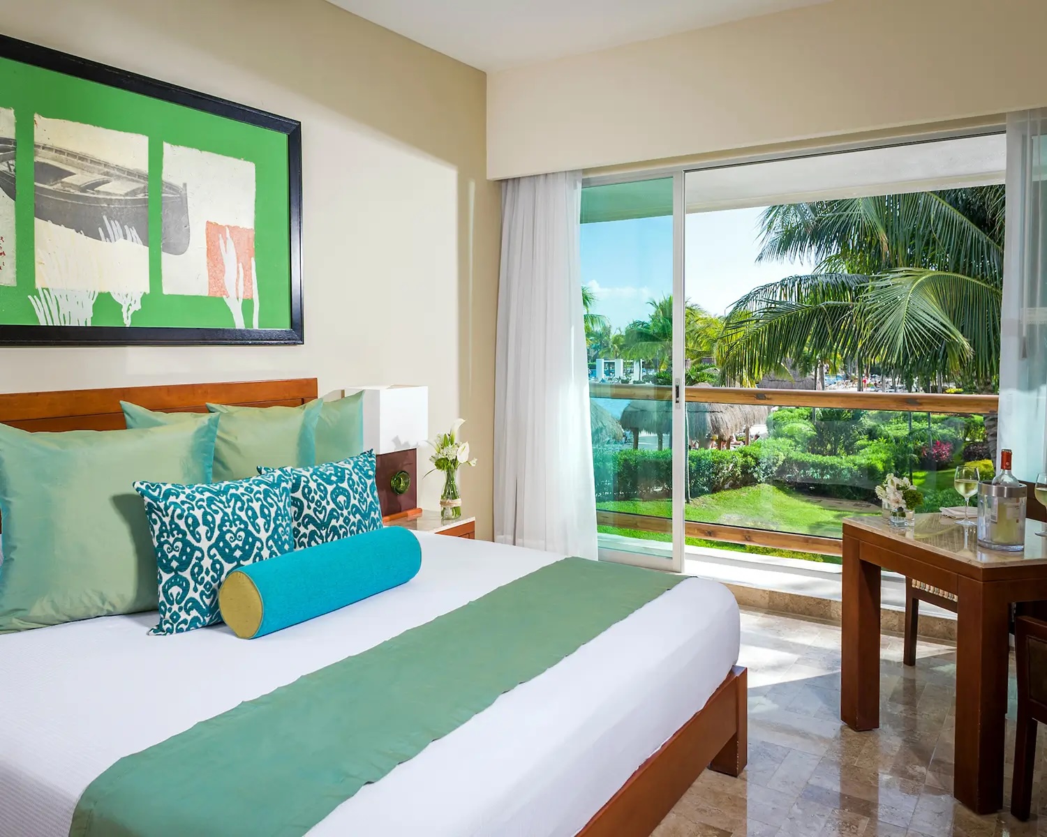 Bedroom of a suite at Mayan Palace, Vidanta Riviera Maya, featuring green and turquoise accents and garden views
