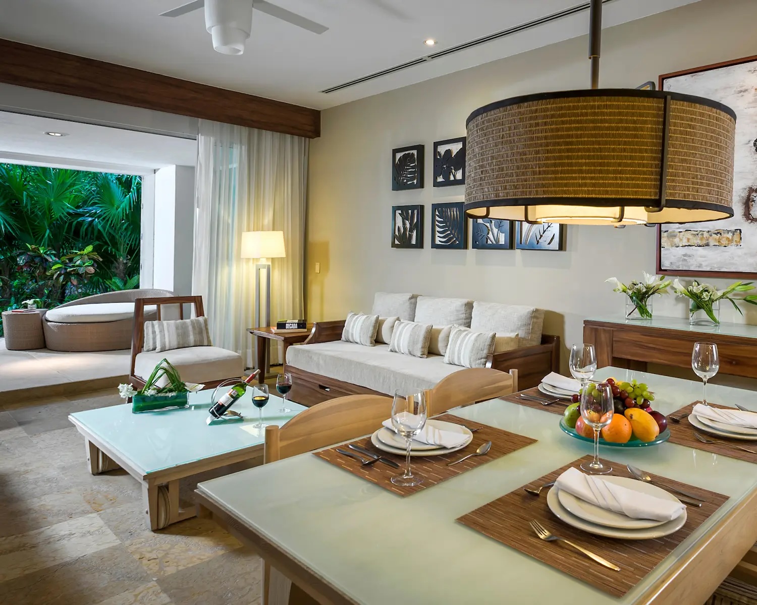 Living and dining area of a suite at Grand Bliss, Vidanta Riviera Maya, featuring wood finishes and garden views